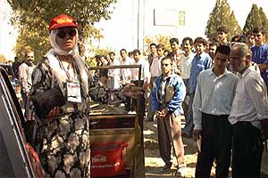 Women drivers such as Linda Dowell draw gawking 
crowds even when covered.